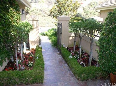 Landscaped gated entry looking toward street