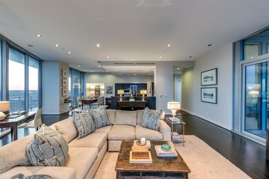 Living room featuring floor to ceiling windows and