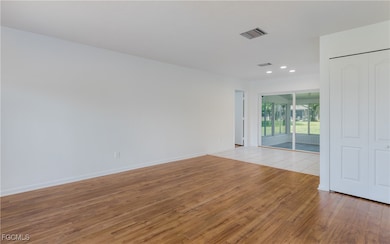 Spare room with light wood-style flooring and recessed lighting