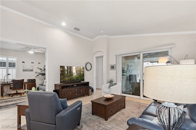 Living room featuring ceiling fan, light tile patt