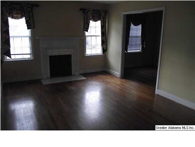 Living room with fireplace and hardwood floors.  I