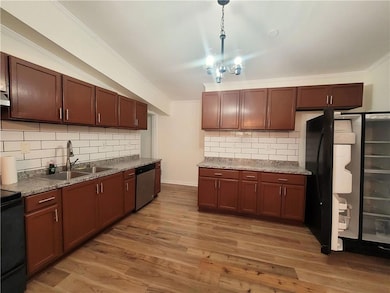 Kitchen with a sink, stainless steel dishwasher, d