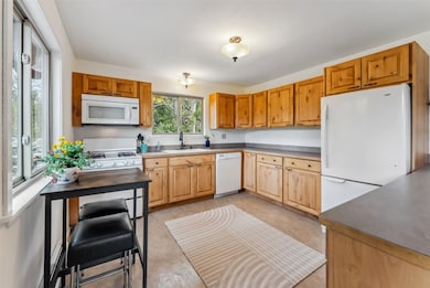 Kitchen featuring white appliances