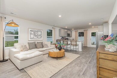 Living room featuring light wood-type flooring, recessed lighting, and baseboards