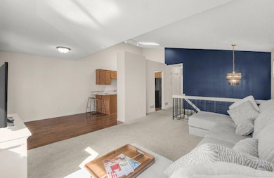 Living room looking into kitchen and dining area.