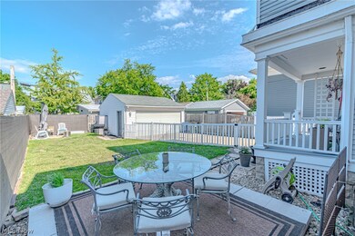 View of patio / terrace featuring a garage and an outbuilding