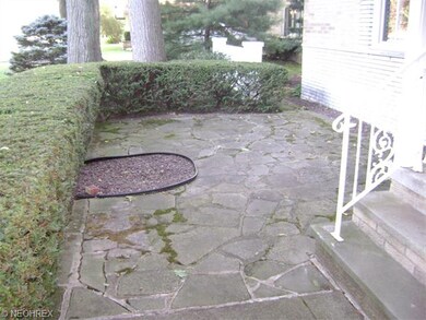 Private flagstone patio with privet privacy screen