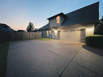 View of front of home featuring driveway, a garage, and brick siding