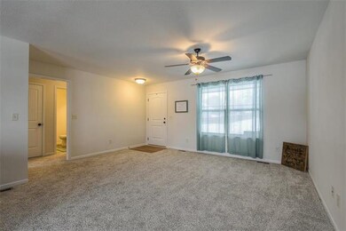 So light and bright living area with ceiling fan.