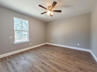 Unfurnished room with light wood finished floors and a ceiling fan