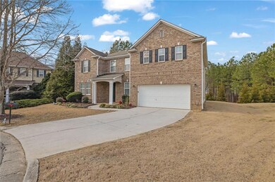 Front facade featuring a garage and a front lawn