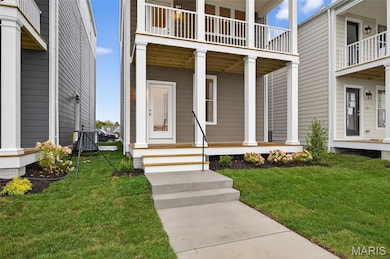 Property entrance with a lawn and a porch