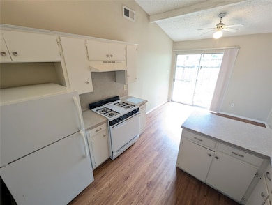 Kitchen featuring white appliances, under cabinet