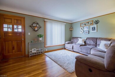 Living room with refinished hard wood floors.