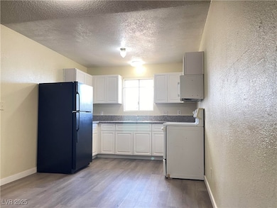 Kitchen with freestanding refrigerator, stove, a t