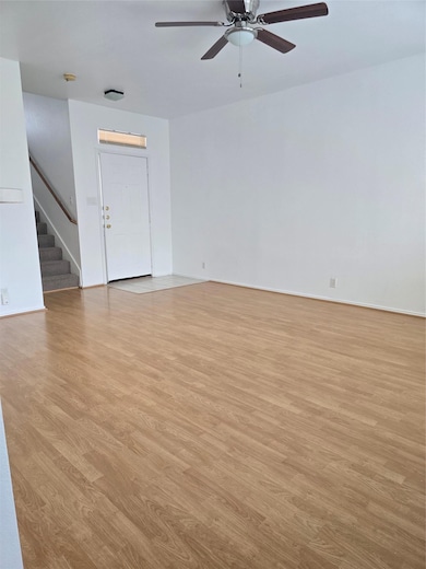 Unfurnished living room with stairs, light wood-s