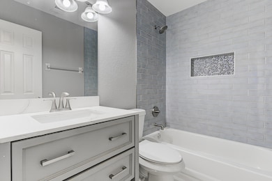 Full bath featuring toilet, shower / tub combinati