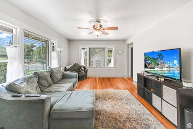 Unit A Living room with wood finished floors and ceiling fan