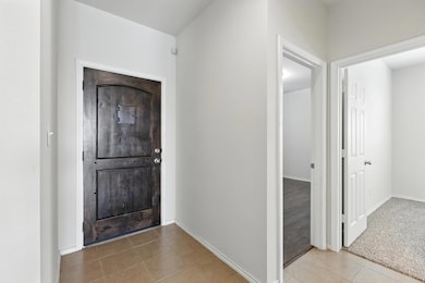 Entrance foyer featuring tile patterned floors an