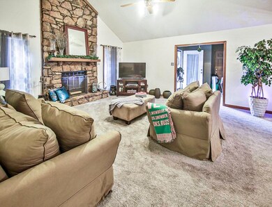 Living room featuring ceiling fan, high vaulted ce