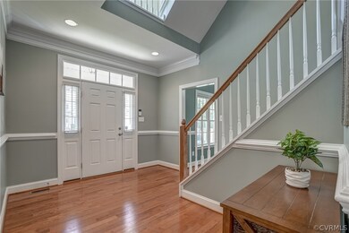 Enter into an open foyer with hardwood floors.