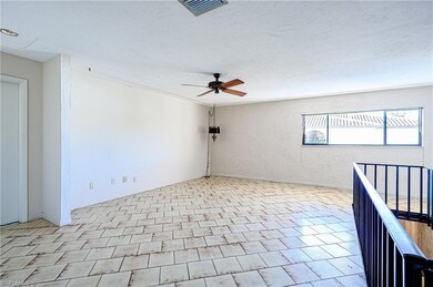 Spare room with visible vents, a textured wall, a 