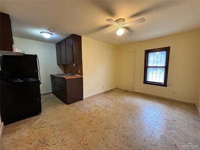 Kitchen featuring sink, ceiling fan, backsplash, dark brown cabinets, and black appliances