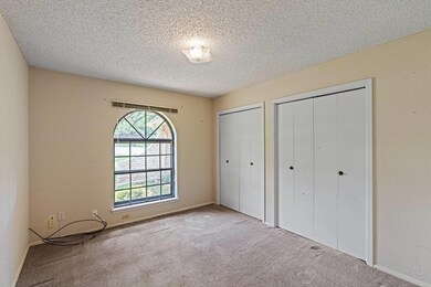Unfurnished bedroom with multiple closets, basebo