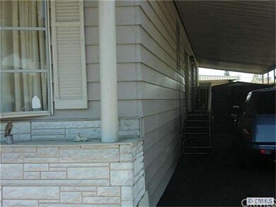 Carport with side entry to family room & shed at e
