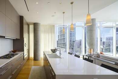 Kitchen featuring expansive windows, a sink, light
