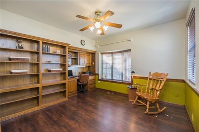 Study with wood floors and built in desk and books
