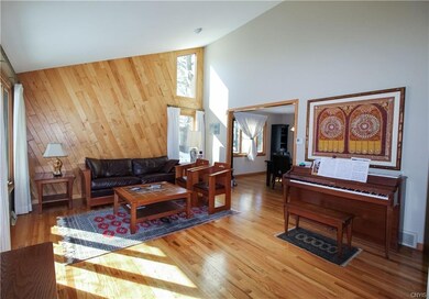 Lignt-filled living room offers cathedral ceilings