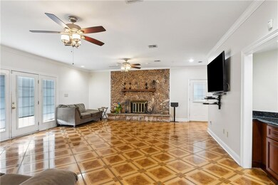 Huge den with wood burning fireplace and French do