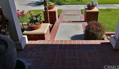Brick-lined cement steps to the entryway.
