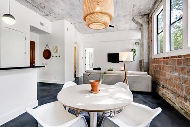 large living and dining area with 12' ceilings.