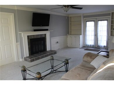 Spacious living room, gas logs, french doors, built in shelves and cabinets