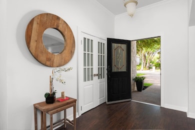 Foyer entrance featuring dark wood-style floors, 