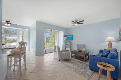 Tiled living room featuring ceiling fan and a heal