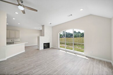 This living area is featured with a double sided fireplace that has been modernized with tile.