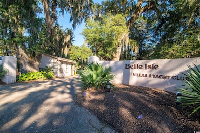 Community sign with view of wooded area