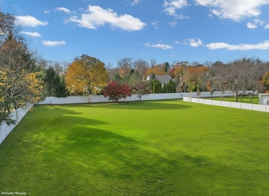 Photo virtually altered to represent rendering of land without existing structures currently present on property