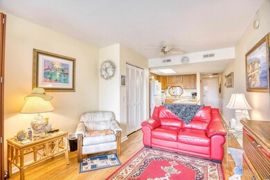 Living room with a textured ceiling, ceiling fan, 
