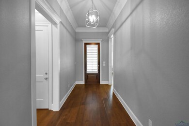 Doorway with a notable chandelier, crown molding, 