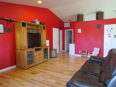 Features wide-plank handscraped hardwood flooring,