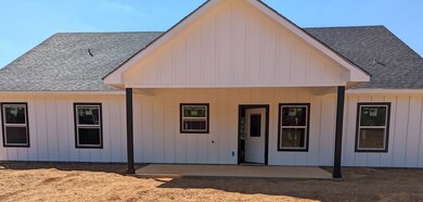 Back side of house with covered patio