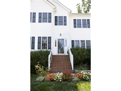 Nicely landscaped front yard with front stoop at e