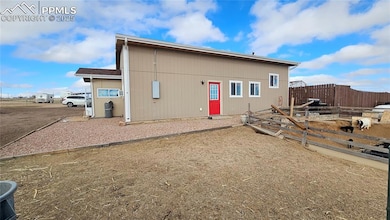 View of outbuilding with fence