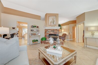 Tiled living room featuring a fireplace and lofted