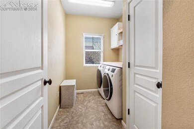 Laundry room with wooden shelves and folding area