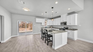 Kitchen featuring light stone countertops, white c